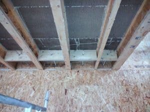 Lateral restraint ties reconnecting outer skin to internal floor joists
