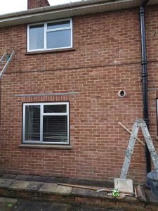 Rear of house showing cavity wall tie failure in brick wall