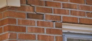 stepped crack in brickwork from corner of window