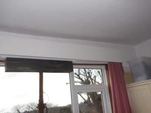 bedroom with sagging ceiling due to failed lintel