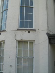 Cracks between windows of two storey bay