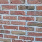 brick wall with vertical cracking