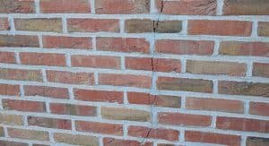 brick wall with vertical cracking